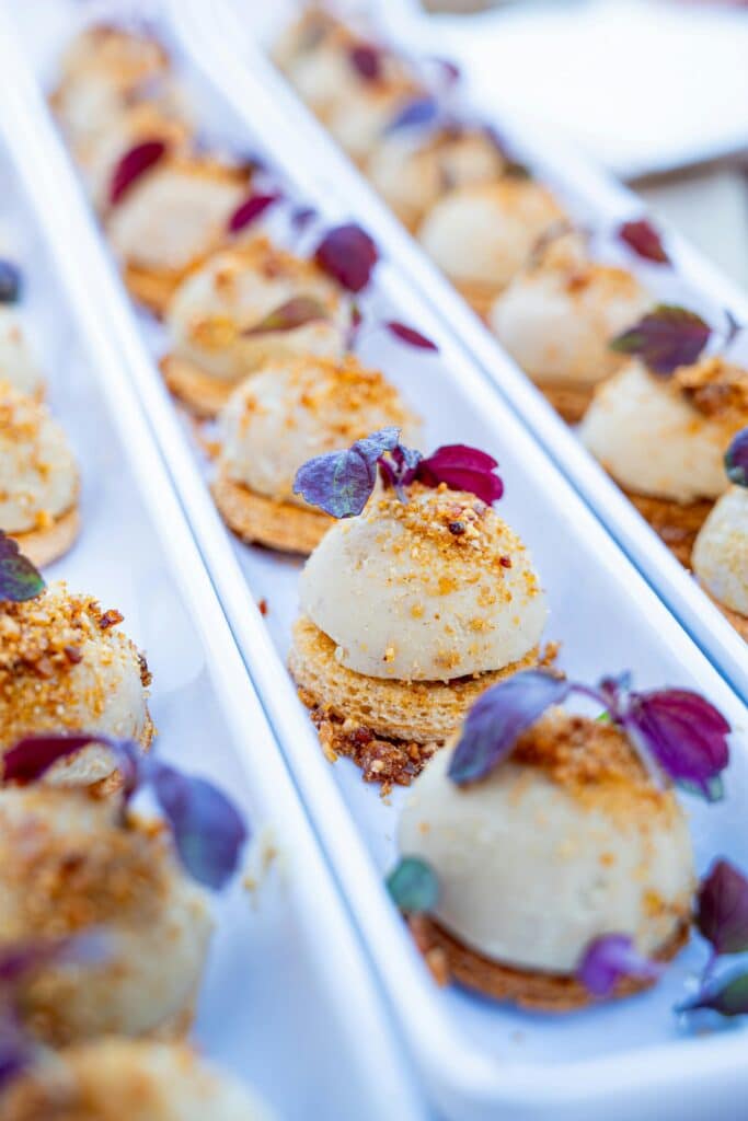 Artfully plated gourmet canapés garnished with microgreens for a luxurious dining experience.